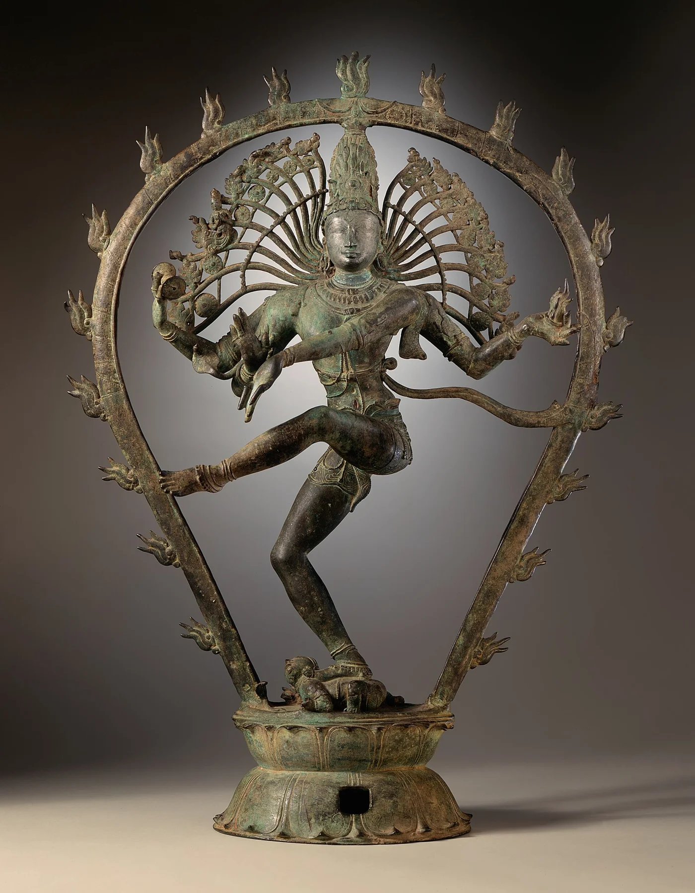 Copper-alloy Shiva dances within a circular frame of flames