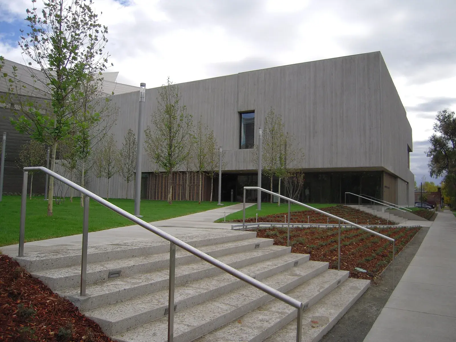Clyfford Still Museum in October 2011 with concrete walls, a narrow window, steps, a ramp and a planted approach