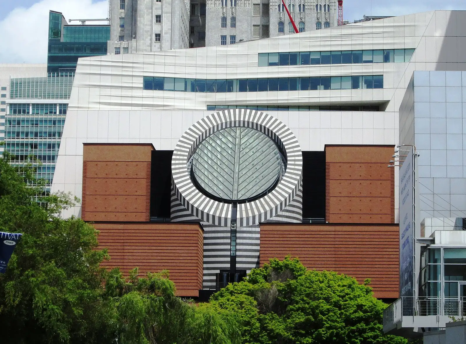 SFMOMA’s brick facade and striped circular roof feature, with its pale modern extension behind