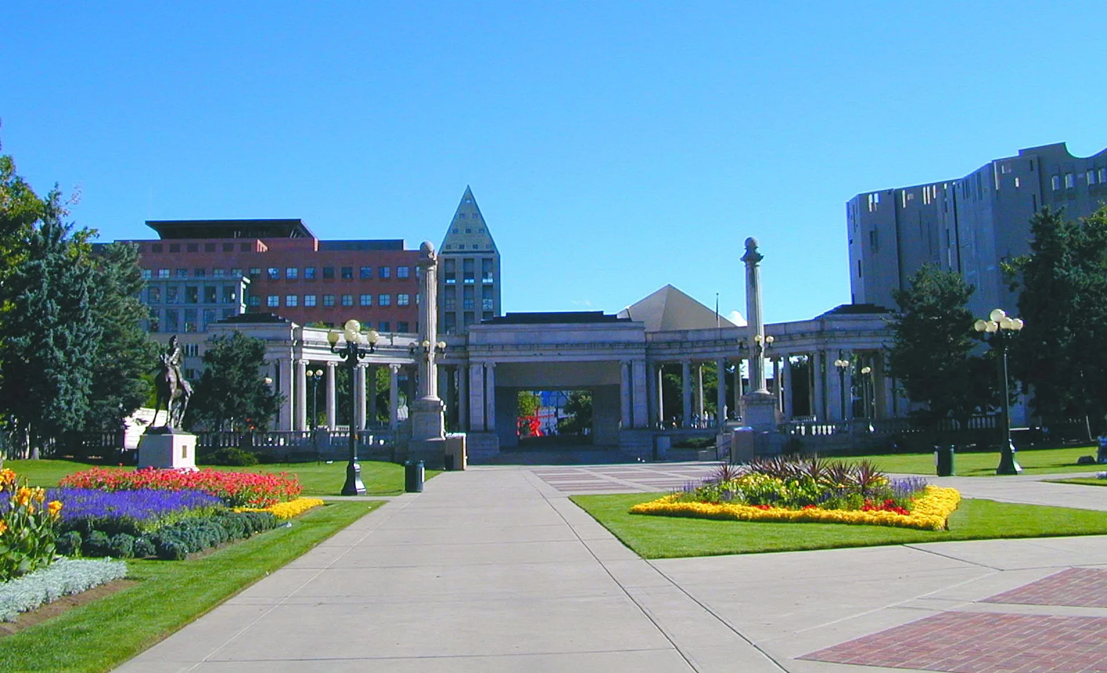 Denver Civic Center with flower beds, lawns, paths and a curved classical colonnade, with the art museum visible behind