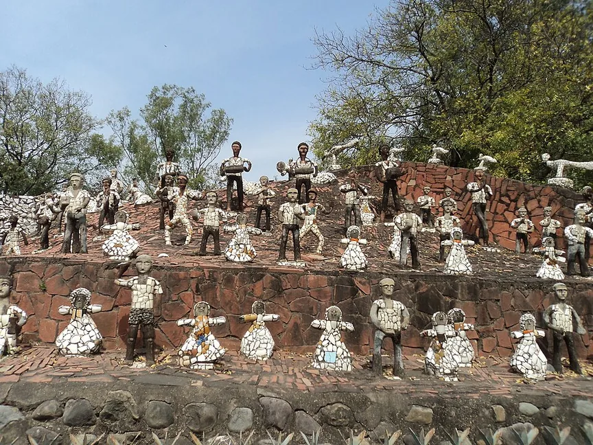 Crowds of human figures covered in broken ceramic mosaic arranged on stepped terraces