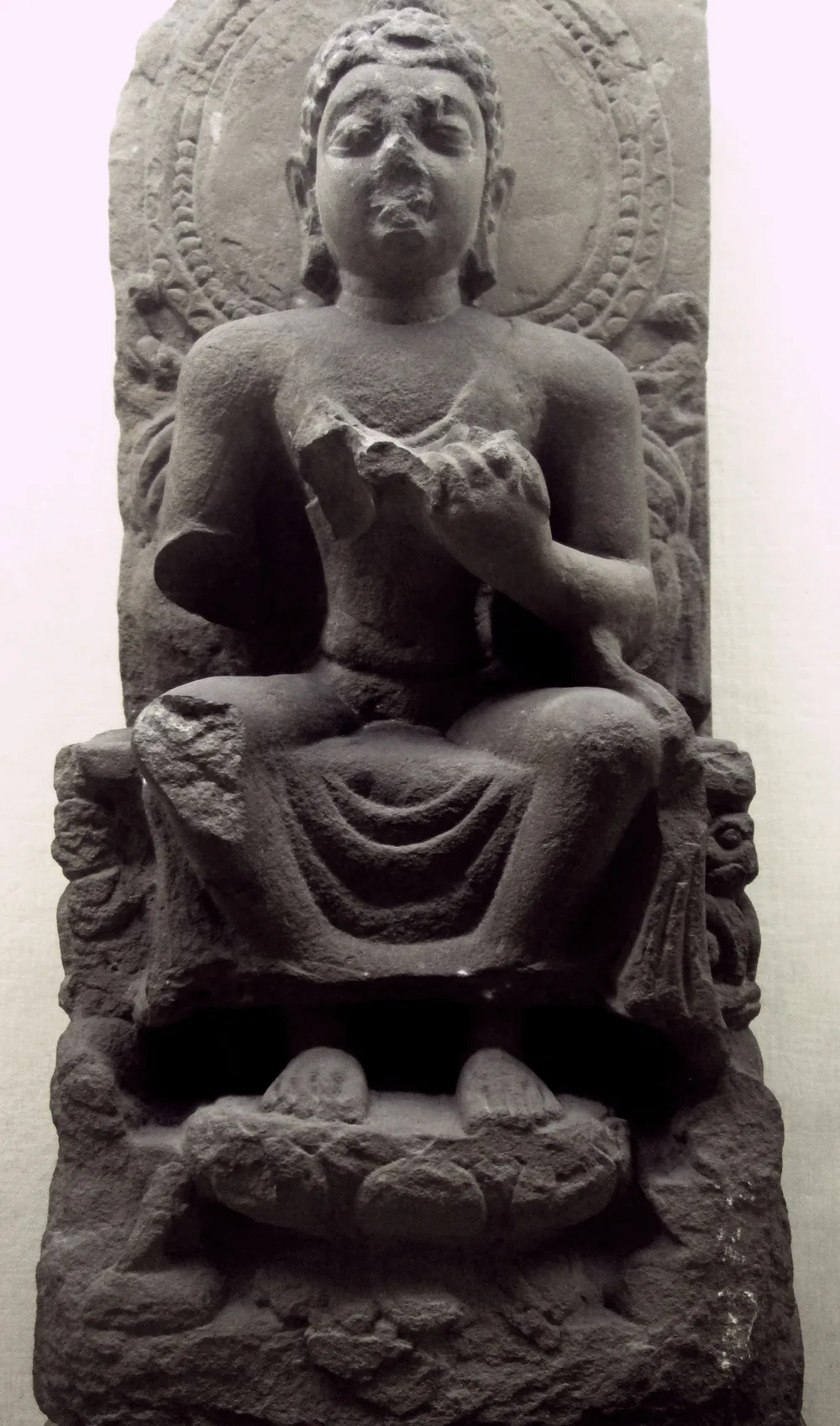 Sandstone seated Buddha from Sarnath, fifth century, hands in the teaching gesture, with a carved halo, in the Indian Museum