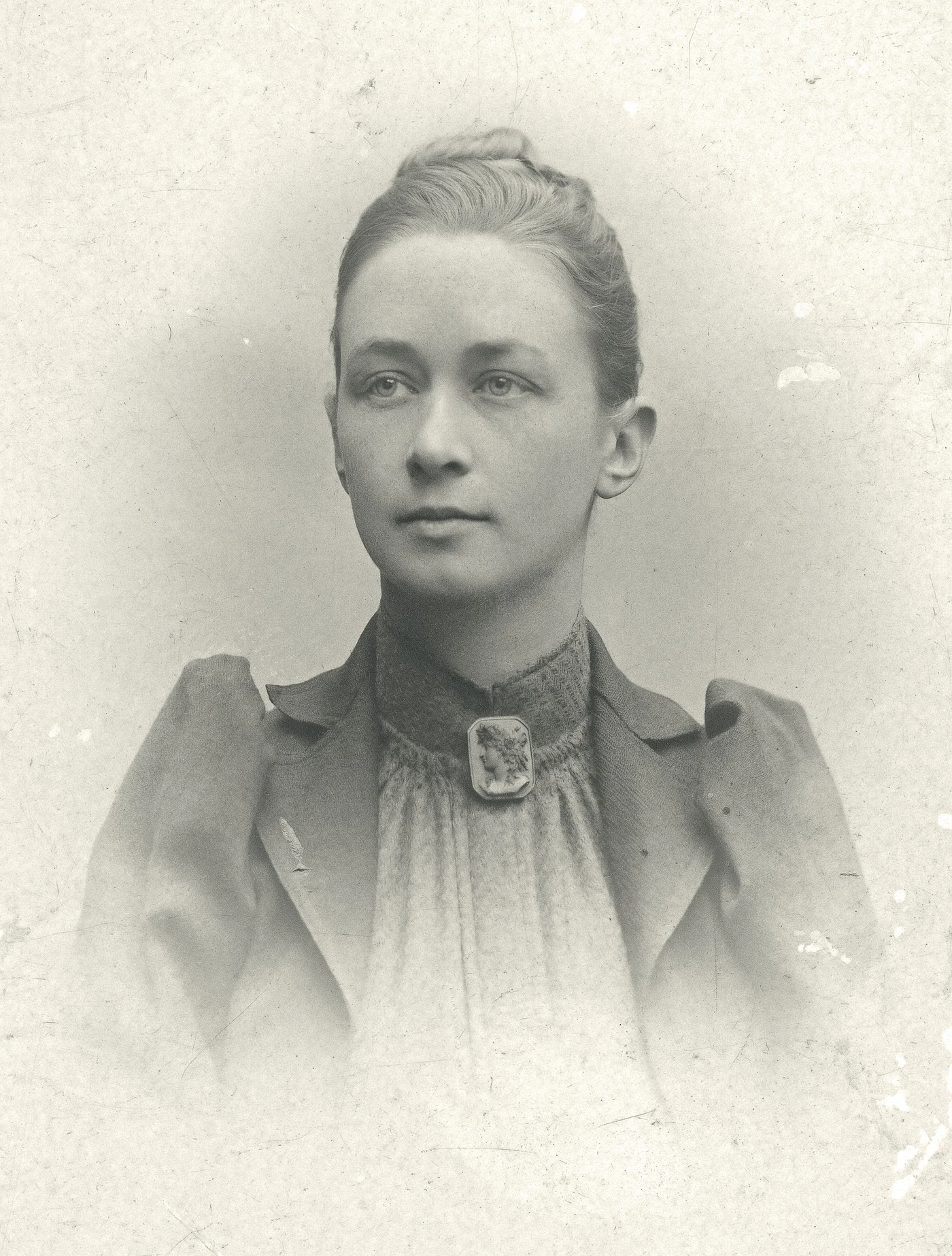 Black-and-white portrait of Hilma af Klint in a pale high-collared blouse with her hair pinned up